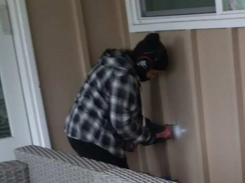 Professional electrician installing an exterior outlet in Spring