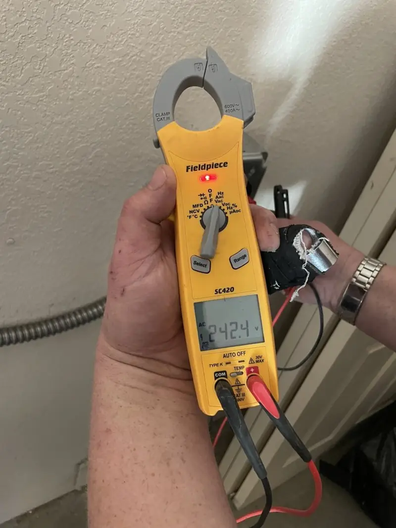Voltage testing with clamp meter during Outlet Installation in Spring